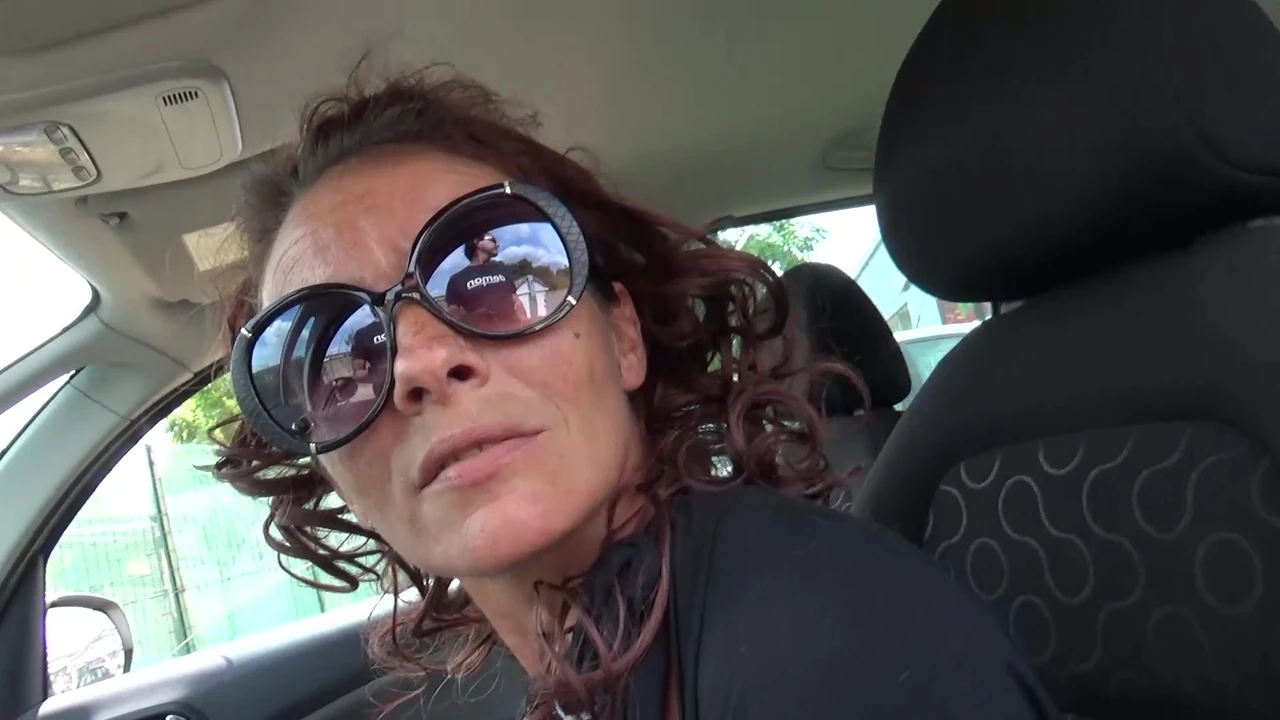 Busty milf performs clandestine act in supermarket parking lot.